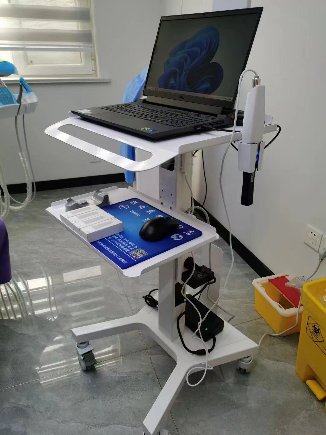 RIFE HA1 dental laptop cart in use at a dental clinic with intraoral scanner holder